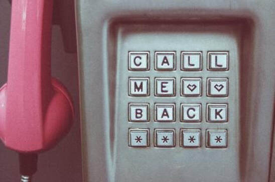 Edited photograph shows a pink telephone next to a dial pad that says, 